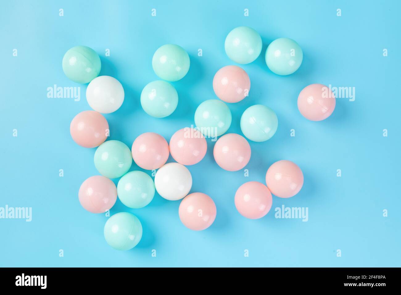 A top view of colorful plastic balls on blue background Stock Photo - Alamy