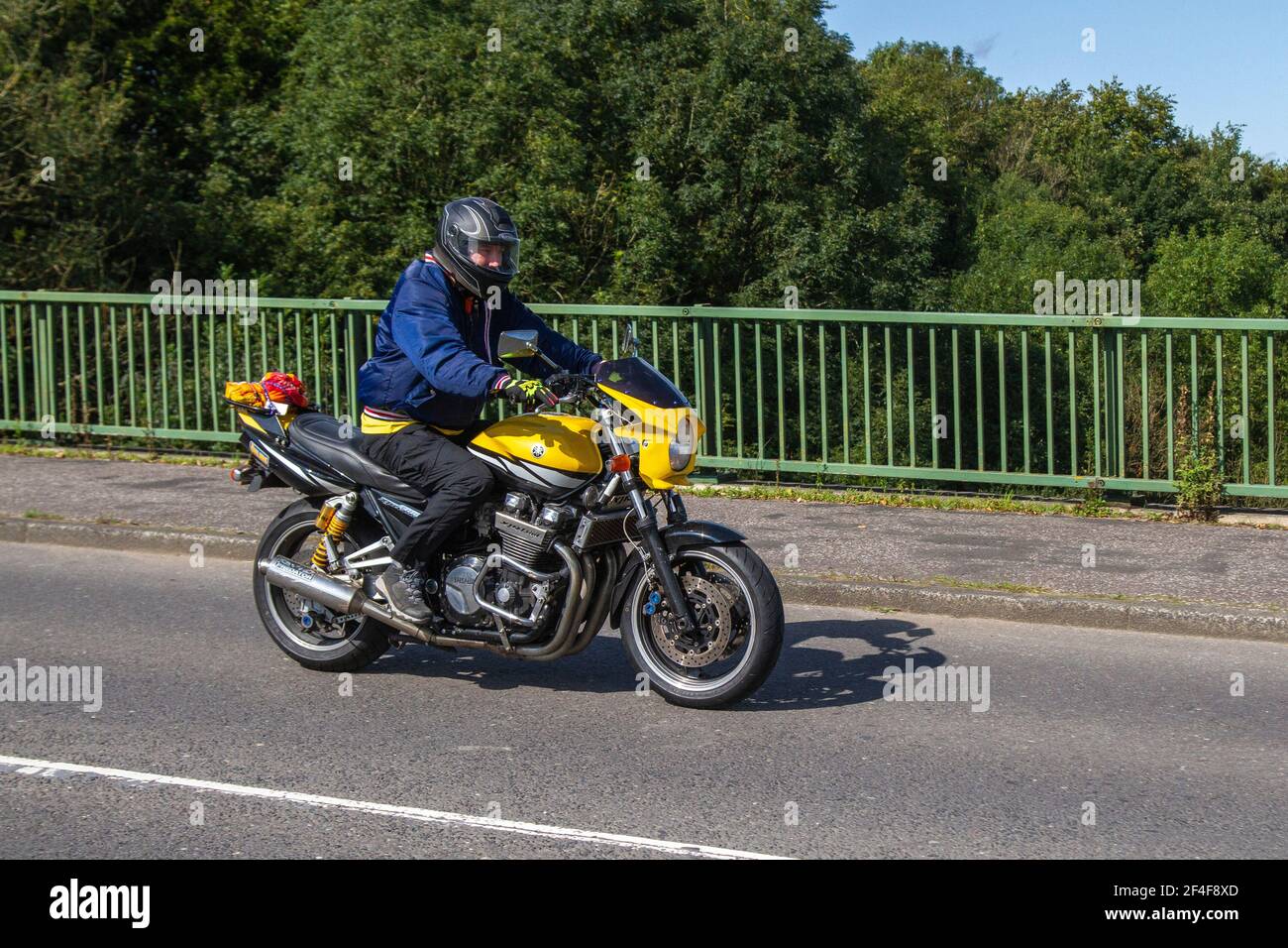 Yellow Yamaha XJR1300 Motorbike rider; two wheeled transport, motorcycles, vehicle, roads, motorbikes, motorcycle bike riders motoring in Manchester, UK Stock Photo