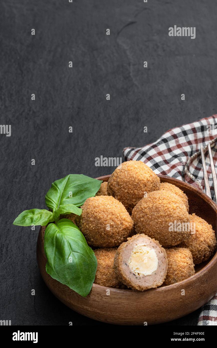 Mini scotch eggs in wooden bowl on black stone background Stock Photo Alamy