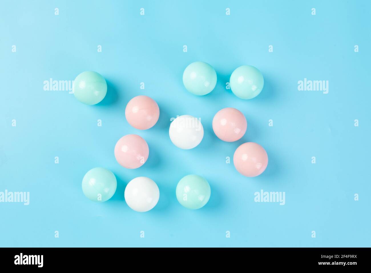 A top vi of colorful plastic balls on blue background Stock Photo - Alamy