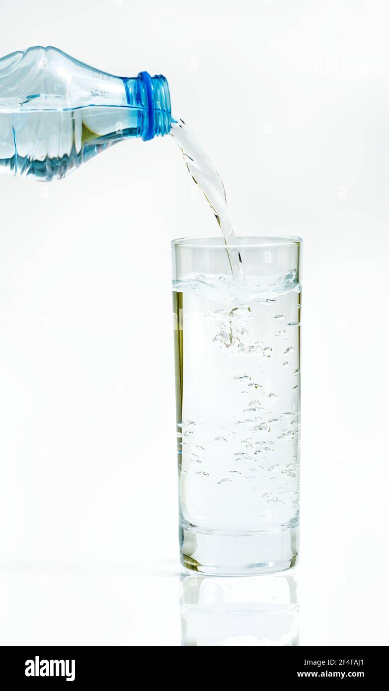 Water bottle pour water to glass on white background Stock Photo Alamy