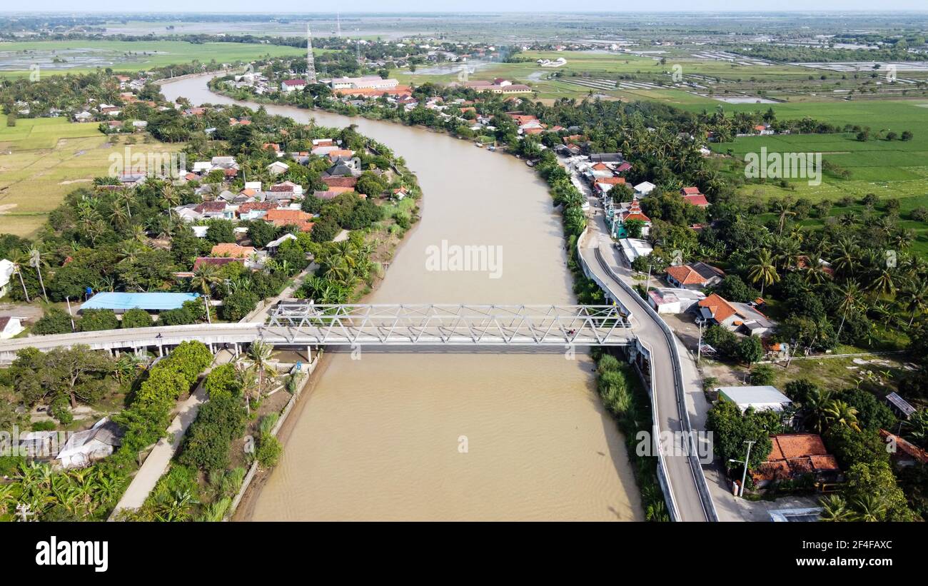 Aerial drone view of A long bridge to the end of the river connects the