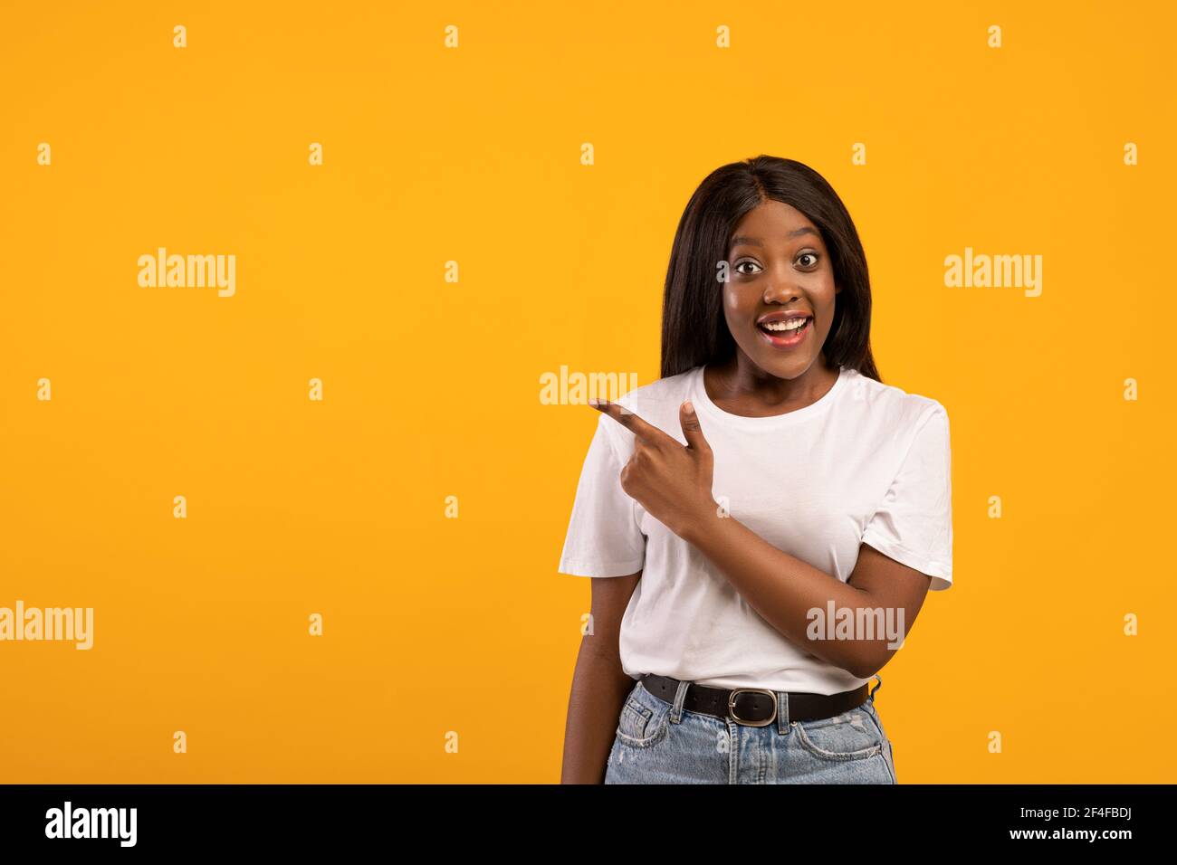 Excited african american woman pointing at empty space Stock Photo