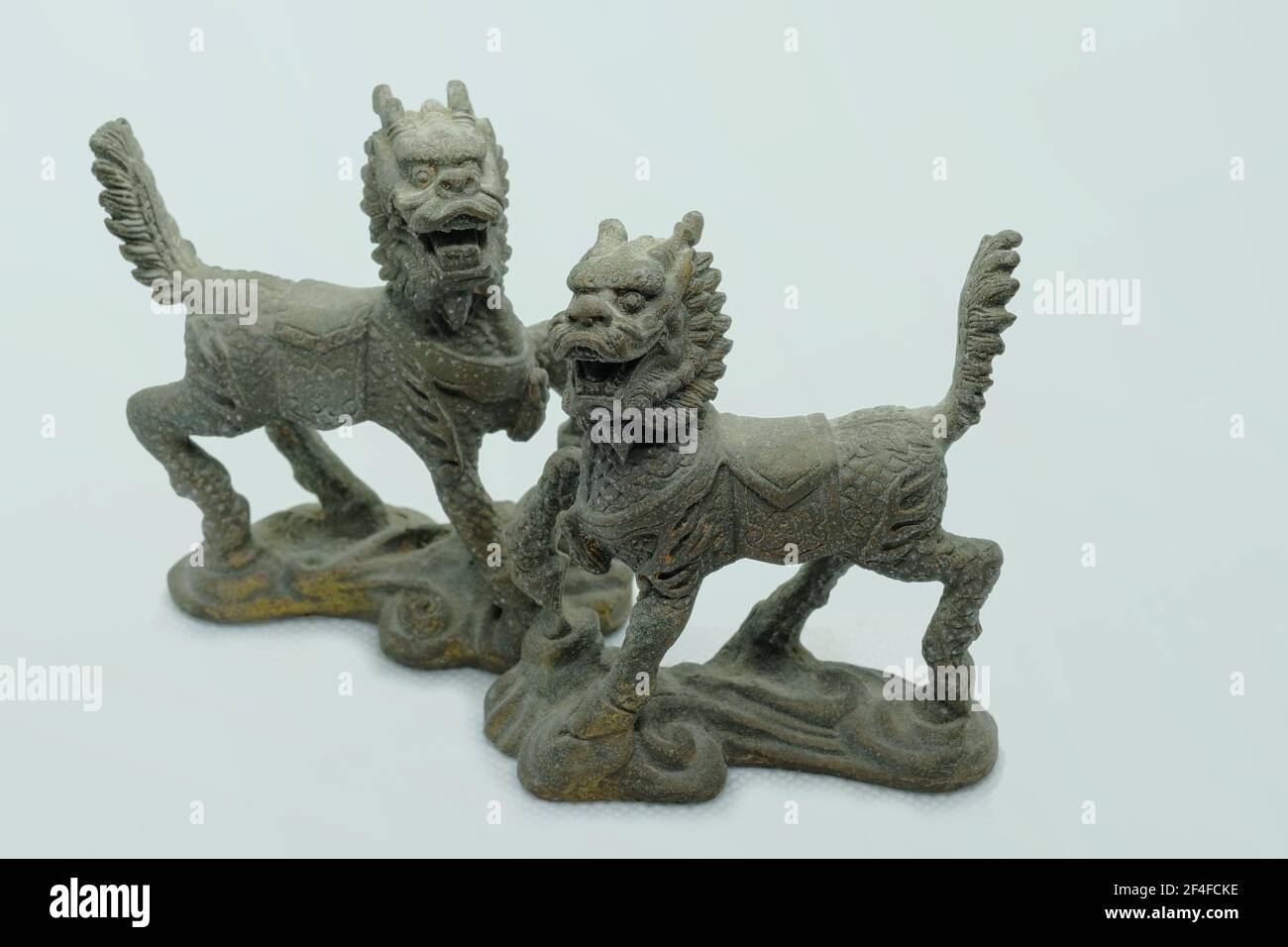 A pair of mythical Chinese bronze Qilin figurines, with head of a ...