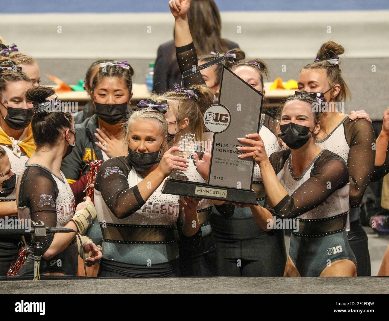 The Minnesota women's gymnastics team poses with the Big 10 trophy