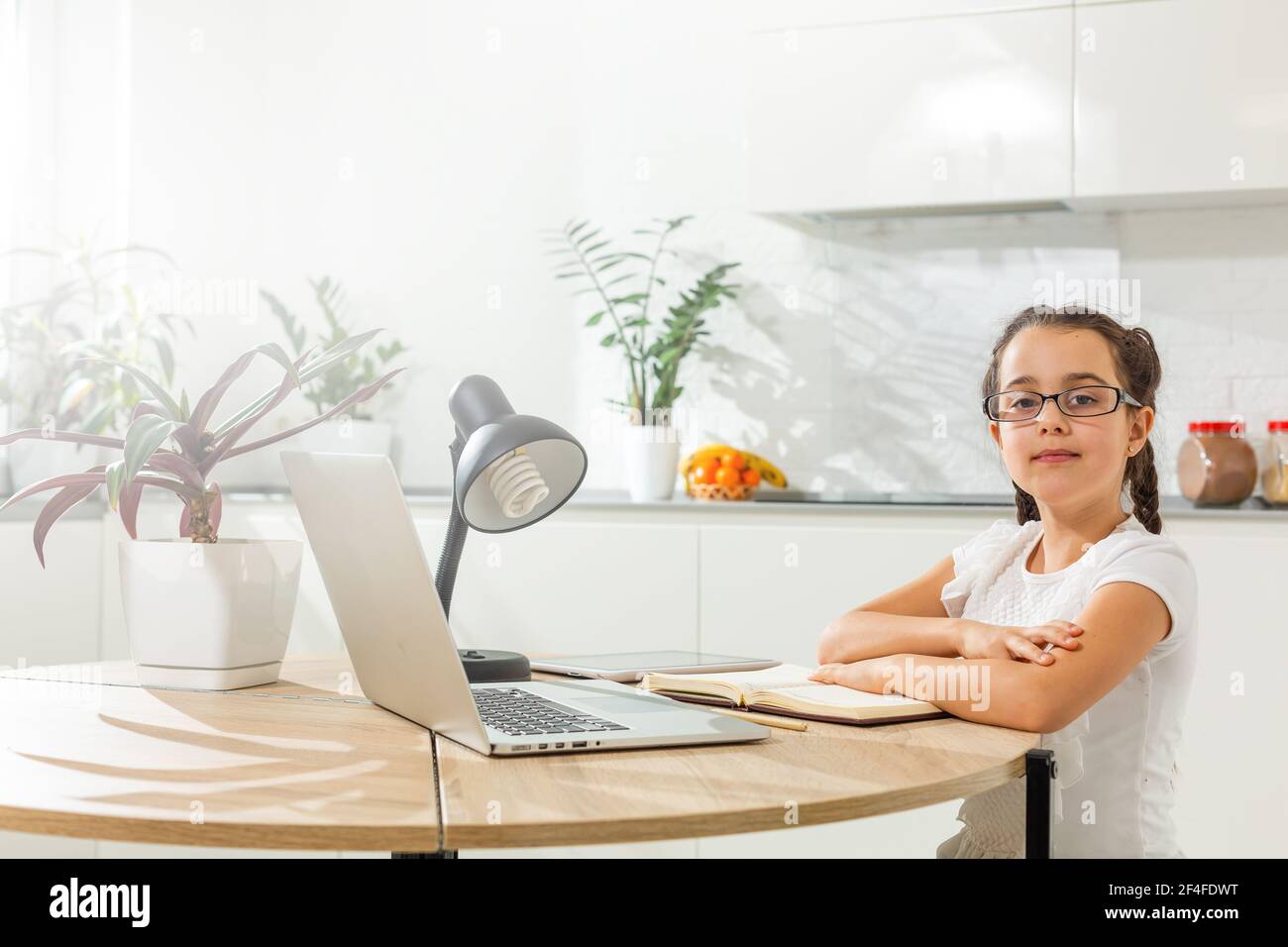 Kids distance learning. Cute little girl using laptop at home ...