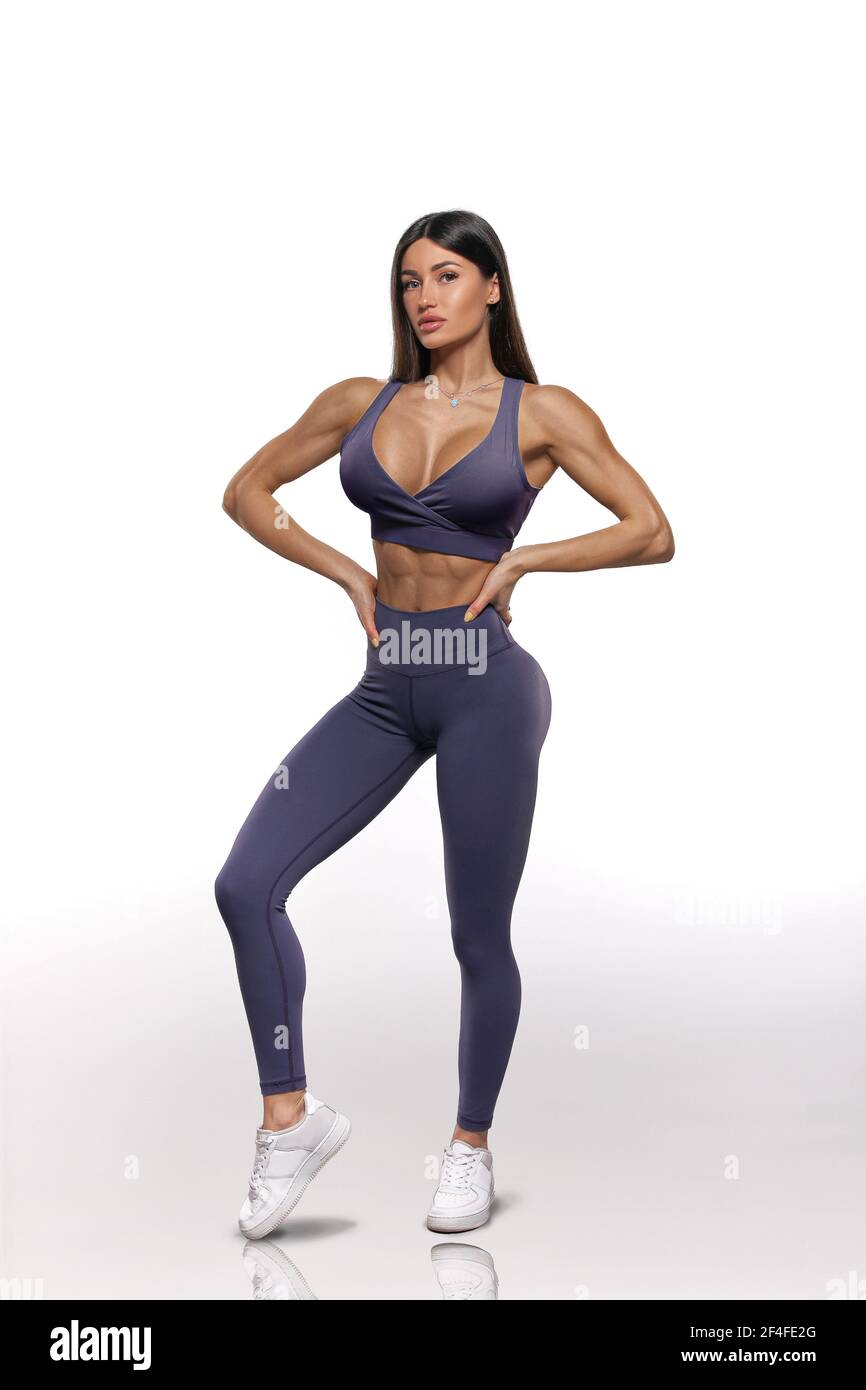 girl in purple leggings and top on a white background Stock Photo