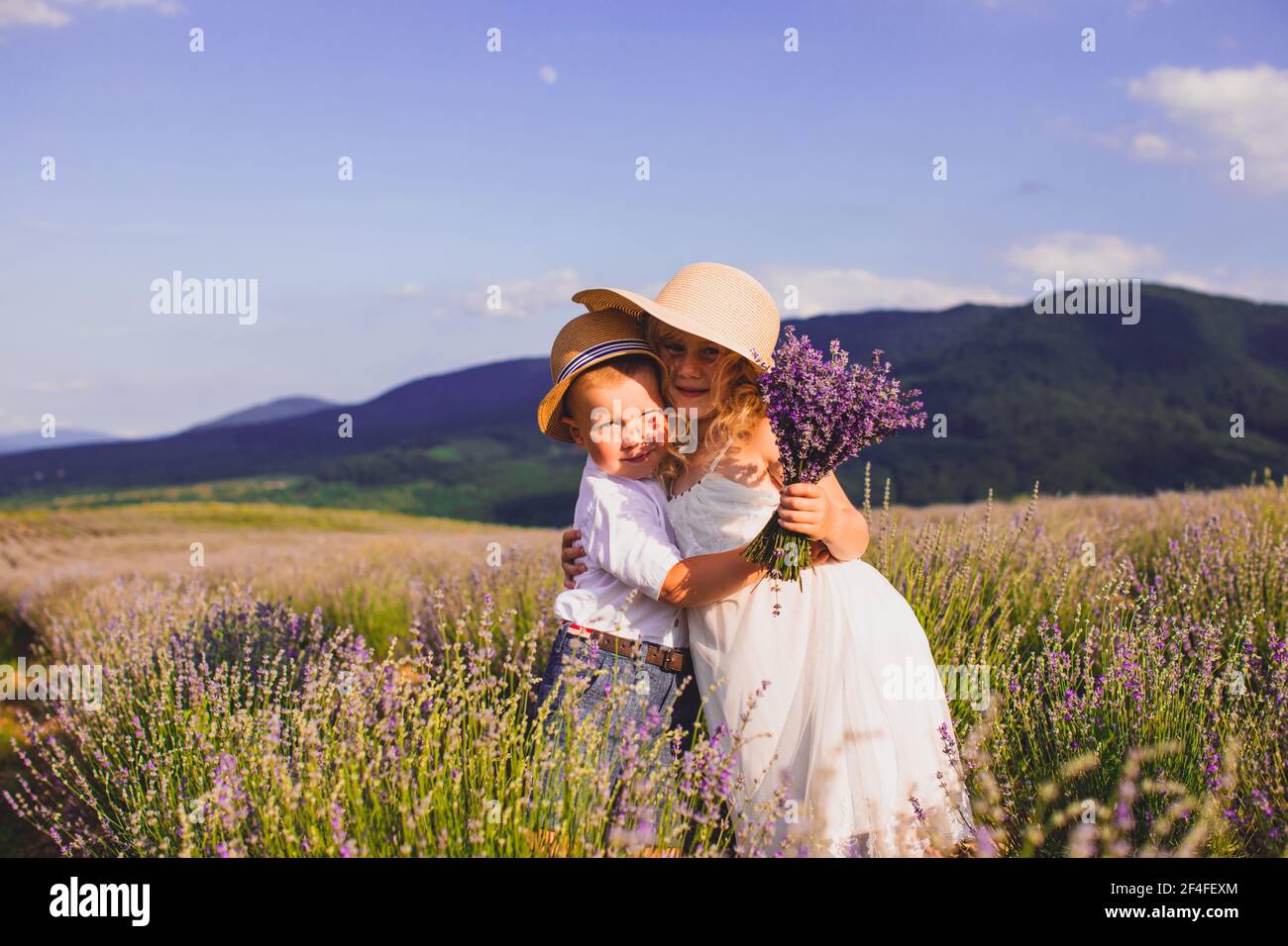 Two adorable kids, boy and girl, standing together Stock Photo - Alamy