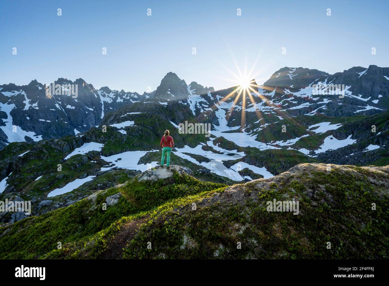 Young woman in the mountains, enjoying the view, mountains and snow