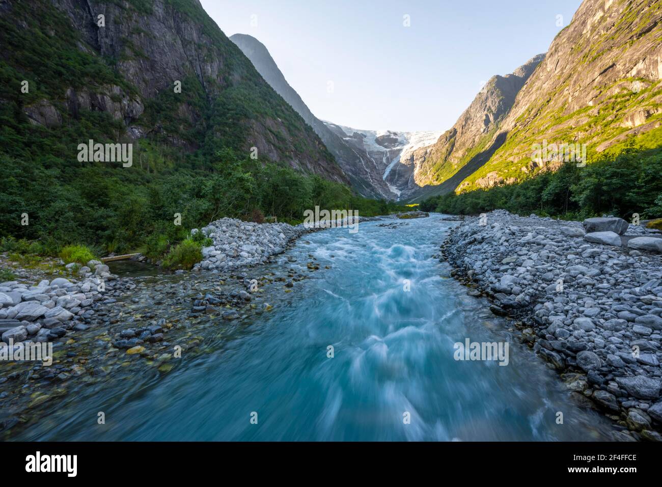 Kjenndalsbreen glacier with glacier river, mountains and waterfalls on steep mountain sides, Loen, Vestland, Norway Stock Photo