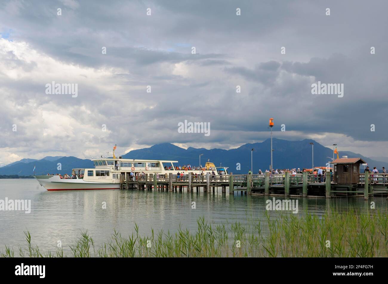 Jetty for excursion boats of the Chiemsee Schifffahrt, July, Fraueninsel, Chiemsee, Chiemgau, Bavaria, Germany Stock Photo