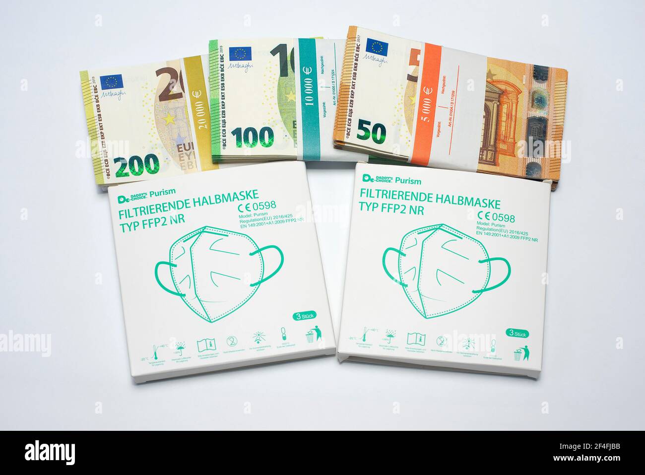 2 packs FFP 2 masks in front of 200, 100, 50 EUR banknote bundles, corruption, Bavaria, Germany Stock Photo