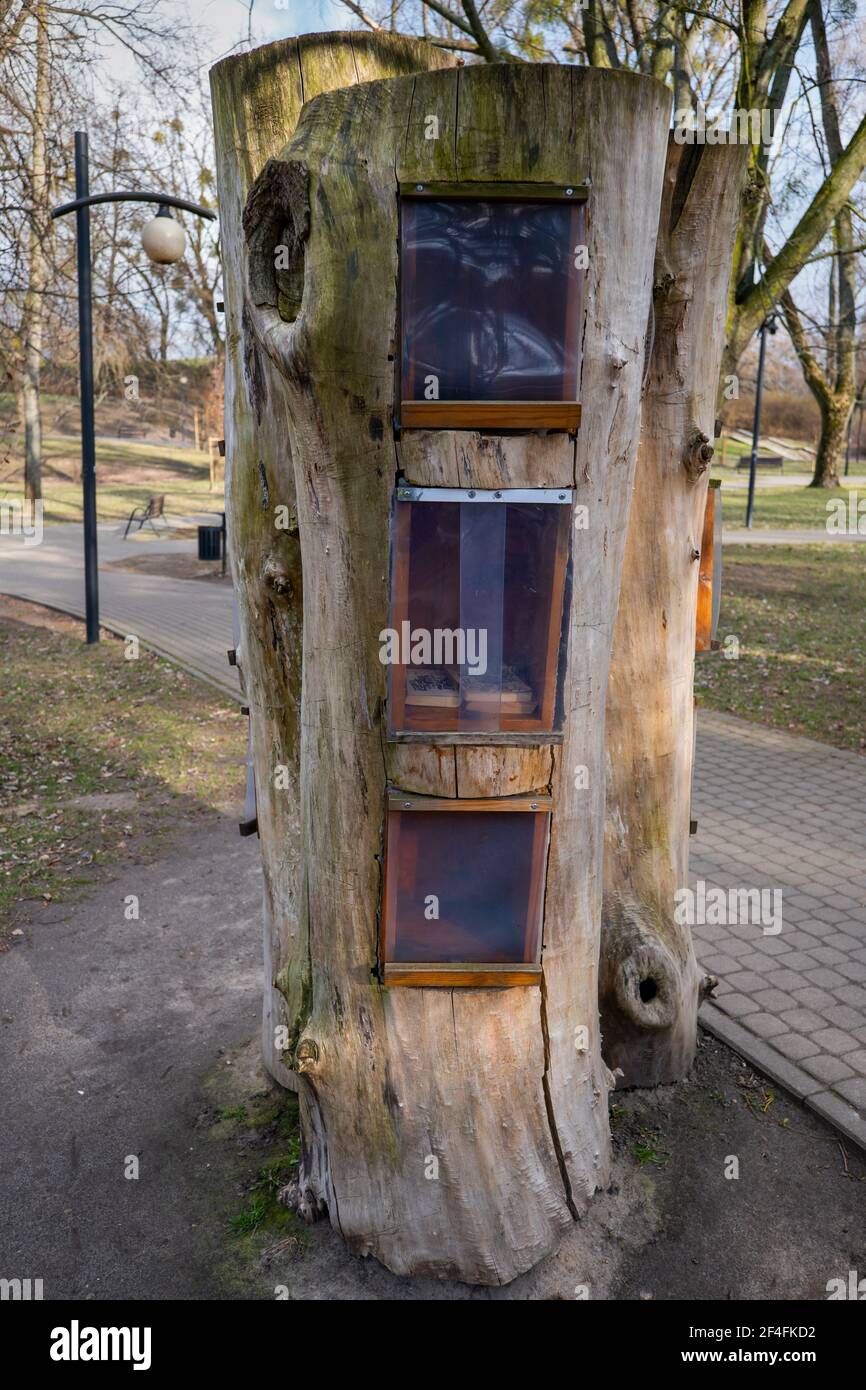 Shelves for used books and magazines in a park, take and return a book sharing bookcase, honour based community book exchange program Stock Photo
