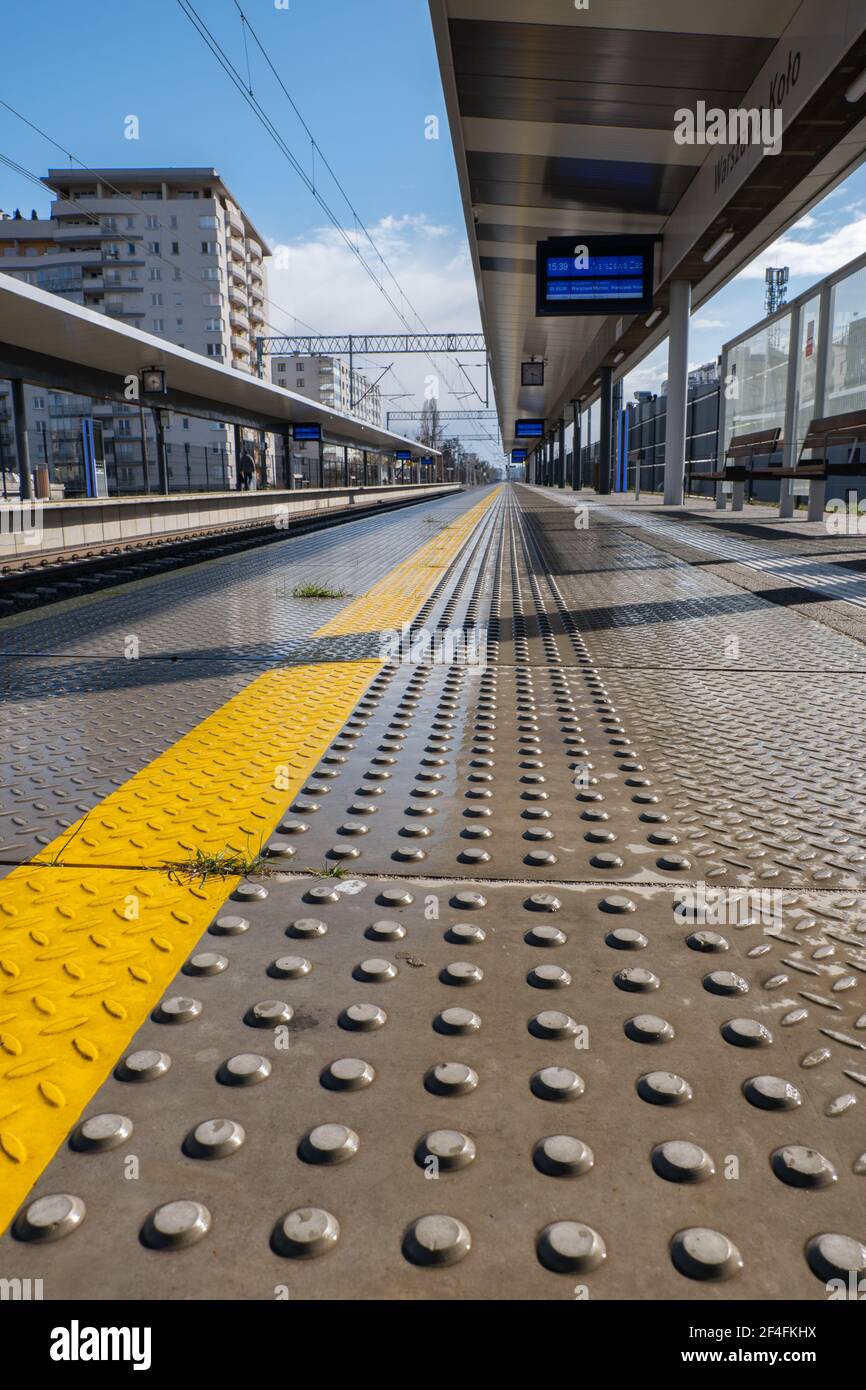 Railway warning surface for blind people, train station platform edge with textured tactile slabs or flooring Stock Photo