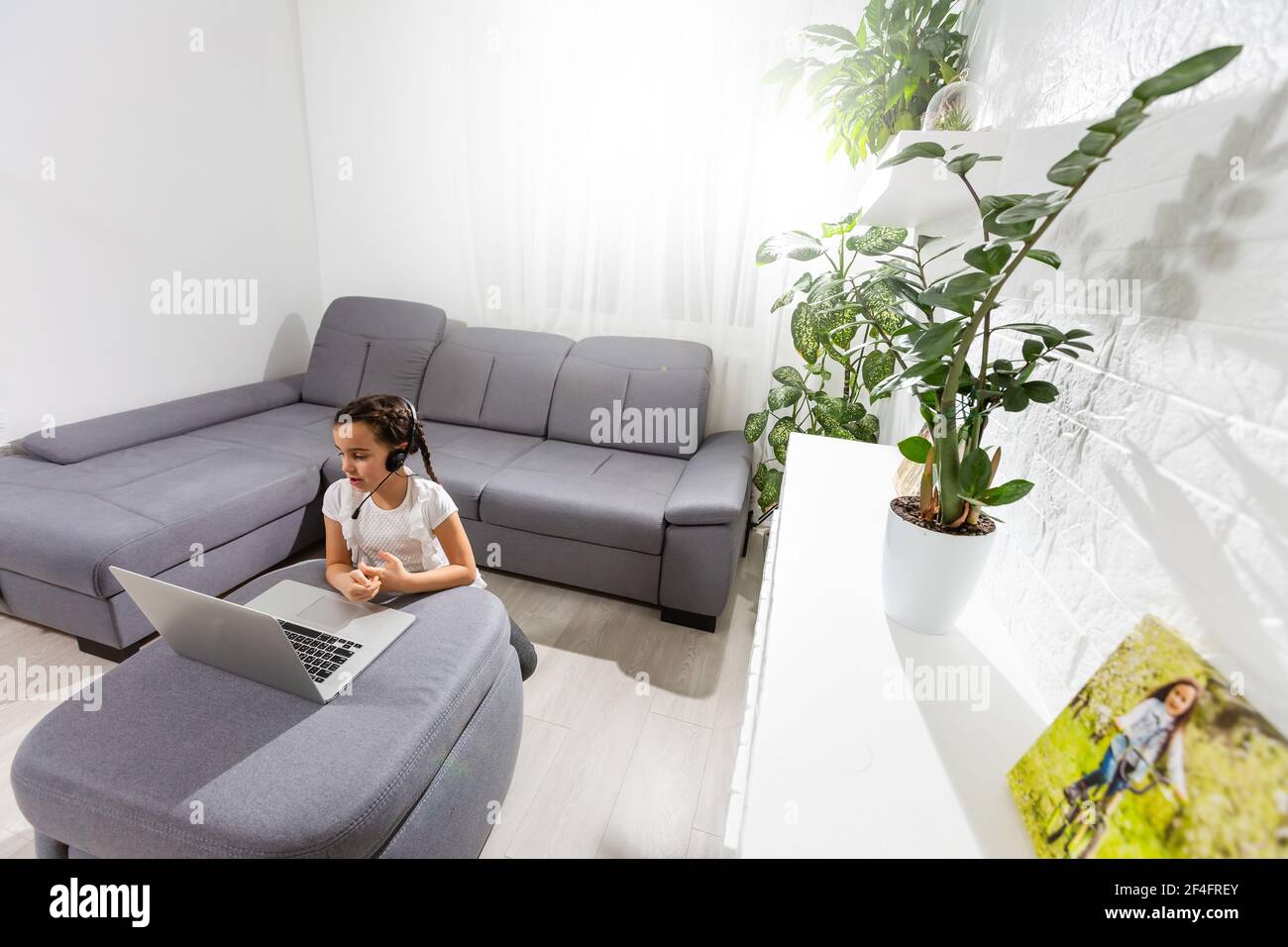 Kids distance learning. Cute little girl using laptop at home ...