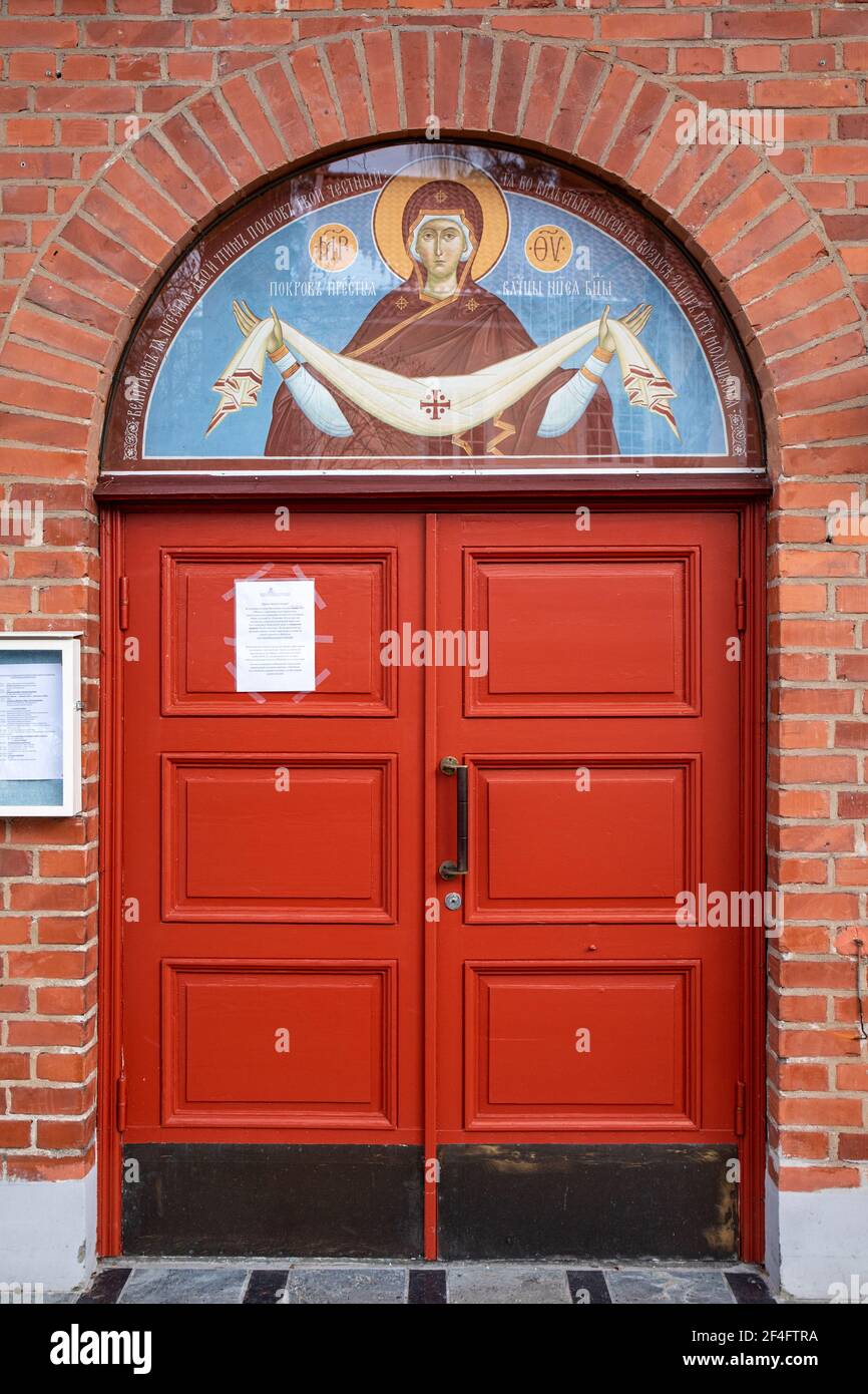 Red doors of Pokrova Eastern Orthodox Church in Munkkiniemi district of