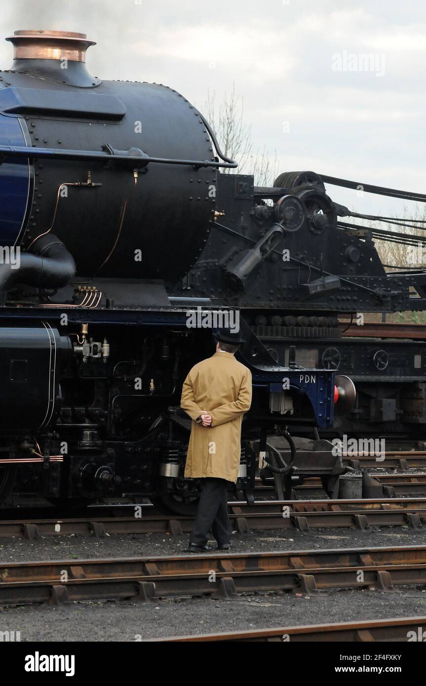 Shed foreman inspecting the front end of 'King Edward II'. Stock Photo