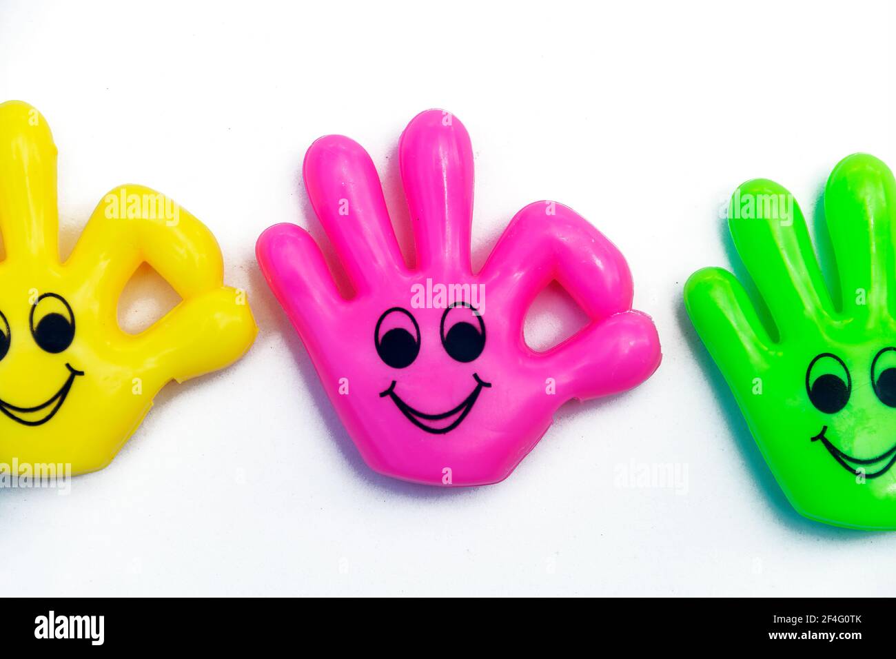 Small plastic hands with smile on face making the OK sign isolated on