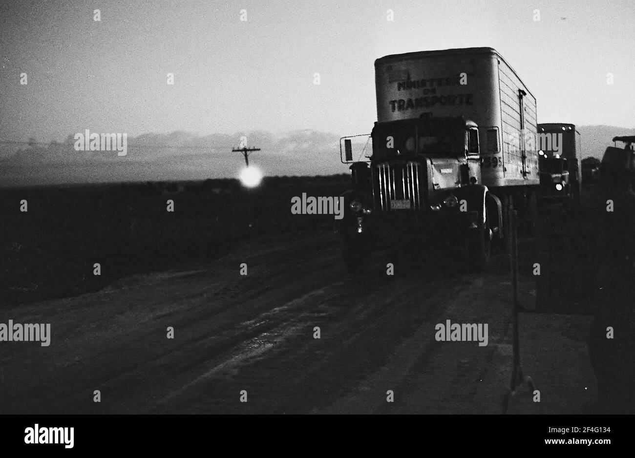 A semi truck drives down a dark road in Cuba, Holguin province, 1963. From the Deena Stryker photographs collection. () Stock Photo