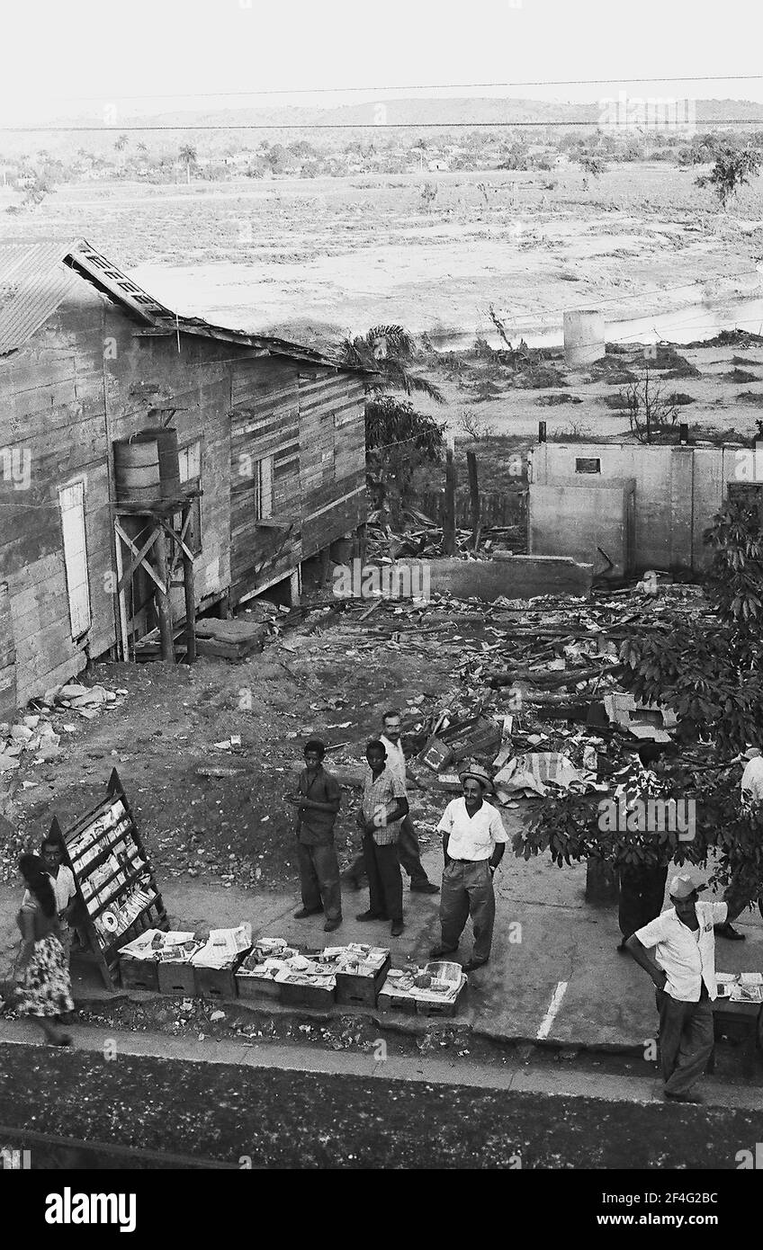 Pinalito after mudslide, aerial view with people selling items in makeshift market stalls beside rubble, Pinalito, Santiago de Cuba, Cuba, 1963. From the Deena Stryker photographs collection. () Stock Photo