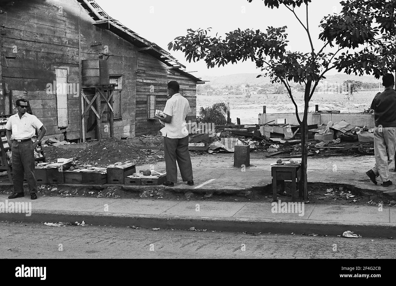 Pinalito after mudslide with people selling items in makeshift market stalls beside rubble, Pinalito, Santiago de Cuba, Cuba, 1963. From the Deena Stryker photographs collection. () Stock Photo
