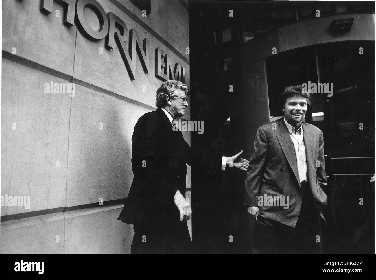 Richard Branson with Chairman and Chief Executive of Thorn EMI Colin outside the Thorn EMI building Businessman and Stock Photo