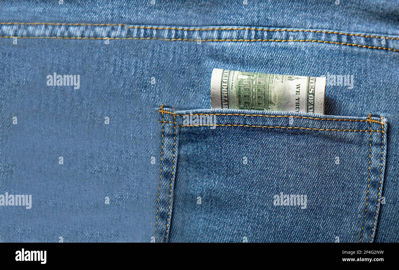 Money in my jeans pocket. Dollars in the back pocket of blue jeans. Place  for text. Copy space Stock Photo - Alamy