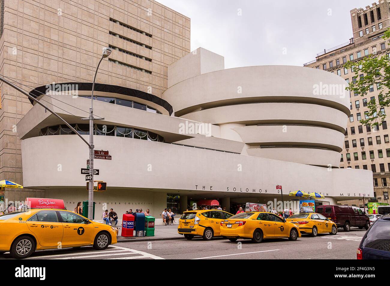 Entrance of the Guggenheim Museum and the cabs waiting outside of the building Stock Photo
