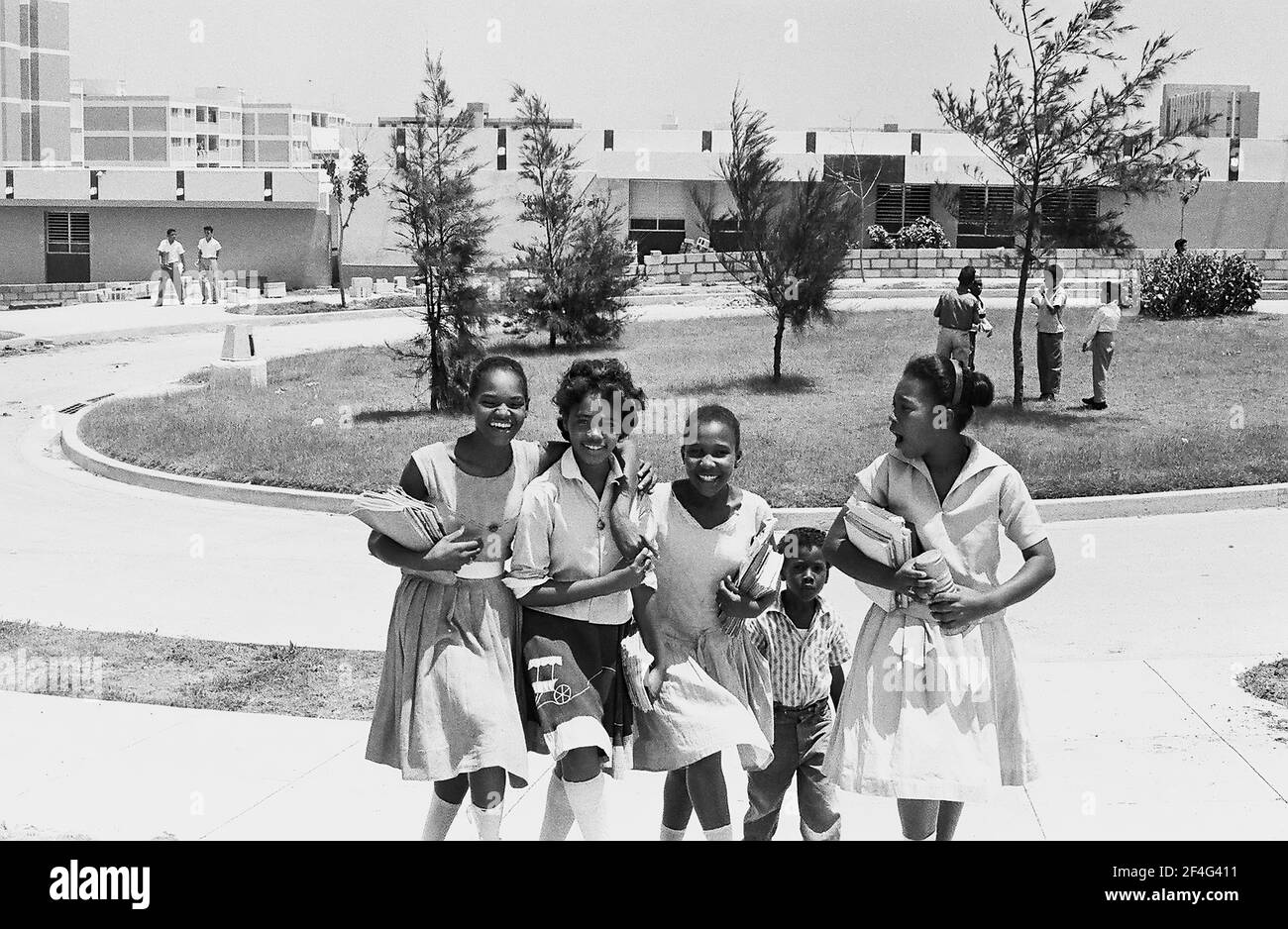 Portrait of five children smiling and posing for a photograph in front of housing in Habana del Este, Havana, Cuba, 1964. From the Deena Stryker photographs collection. () Stock Photo