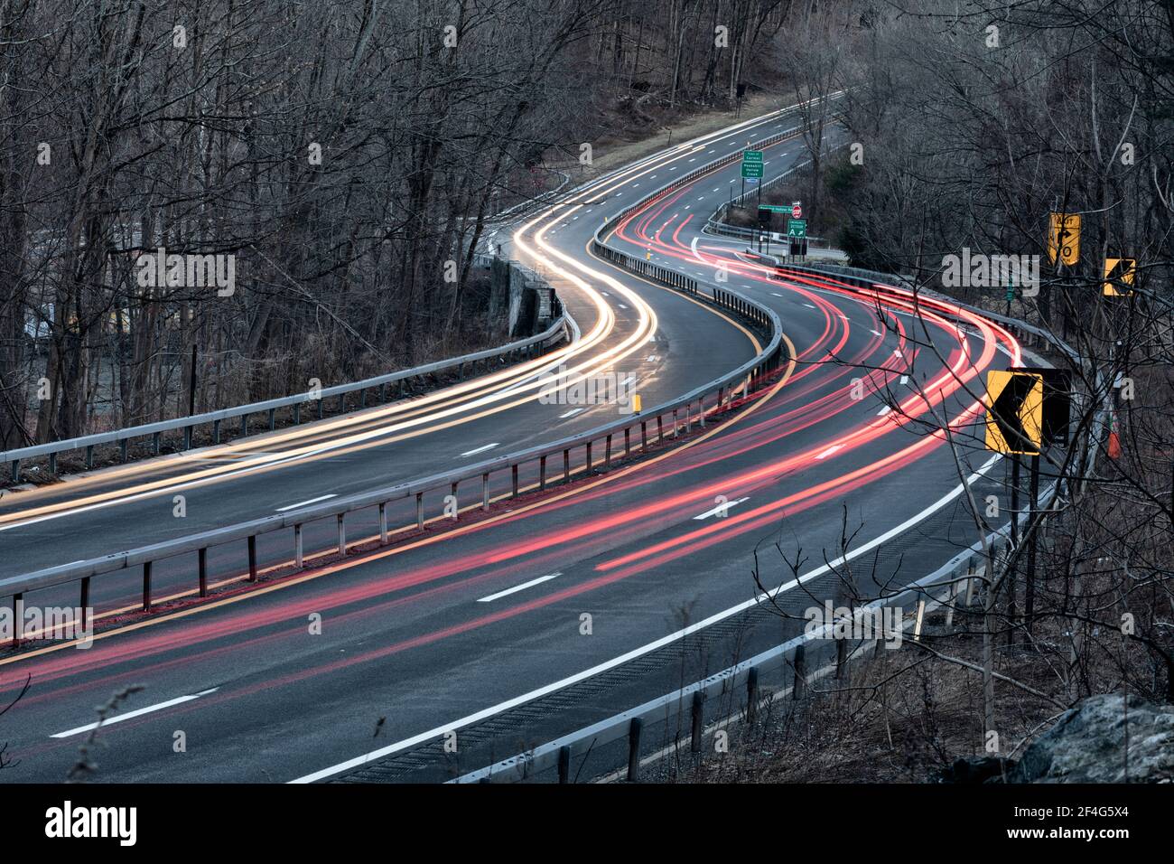 Rush hour traffic blurred by a slow camera shutter speed on the Taconic State Parkway in Putnam County, New York. Stock Photo