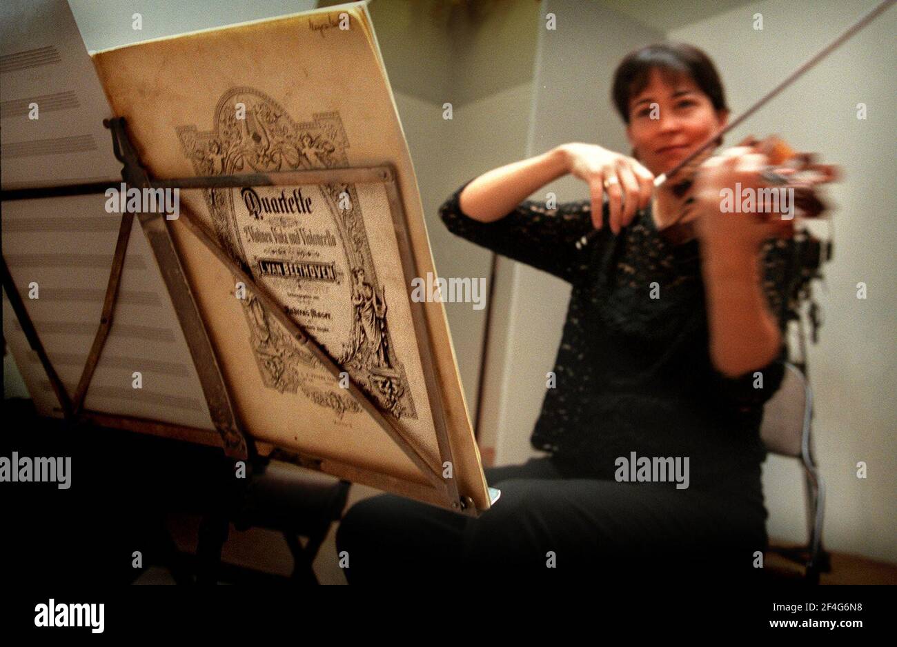 Female violinist playing from a Beethoven Manuscript. Stock Photo