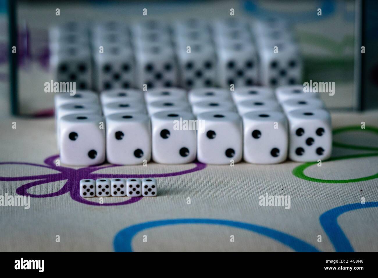 white dice larger, smaller and a mirror showing the other side of the