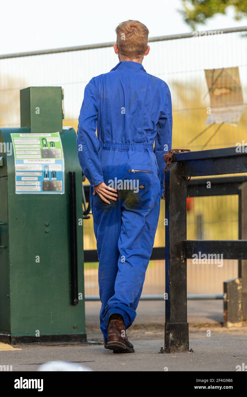Man wearing overalls with a stain on his bottom Stock Photo Alamy