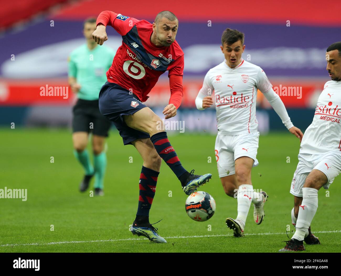 Soccer Football - Ligue 1 - Lille v Nimes Olympique - Stade Pierre-Mauroy,  Lille, France - March 21, 2021 Lille's Burak Yilmaz in action with Nimes  Olympique's Andres Cubas REUTERS/Pascal Rossignol Stock Photo - Alamy
