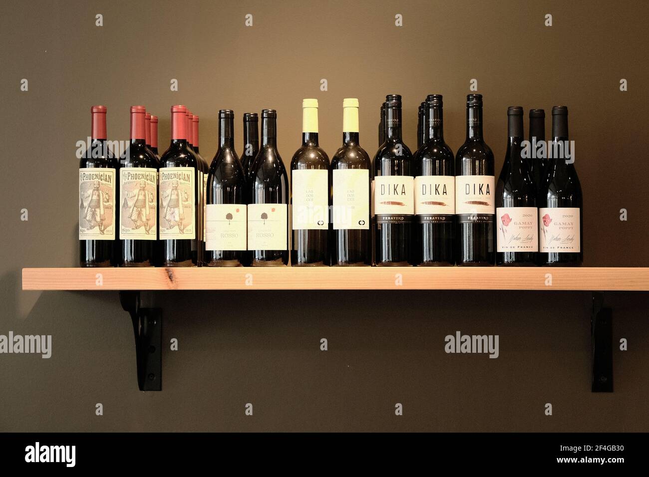 Rows of wine bottles on a shelf - a selection of local wines at a funky cafe in Ottawa, Ontario, Canada. Stock Photo