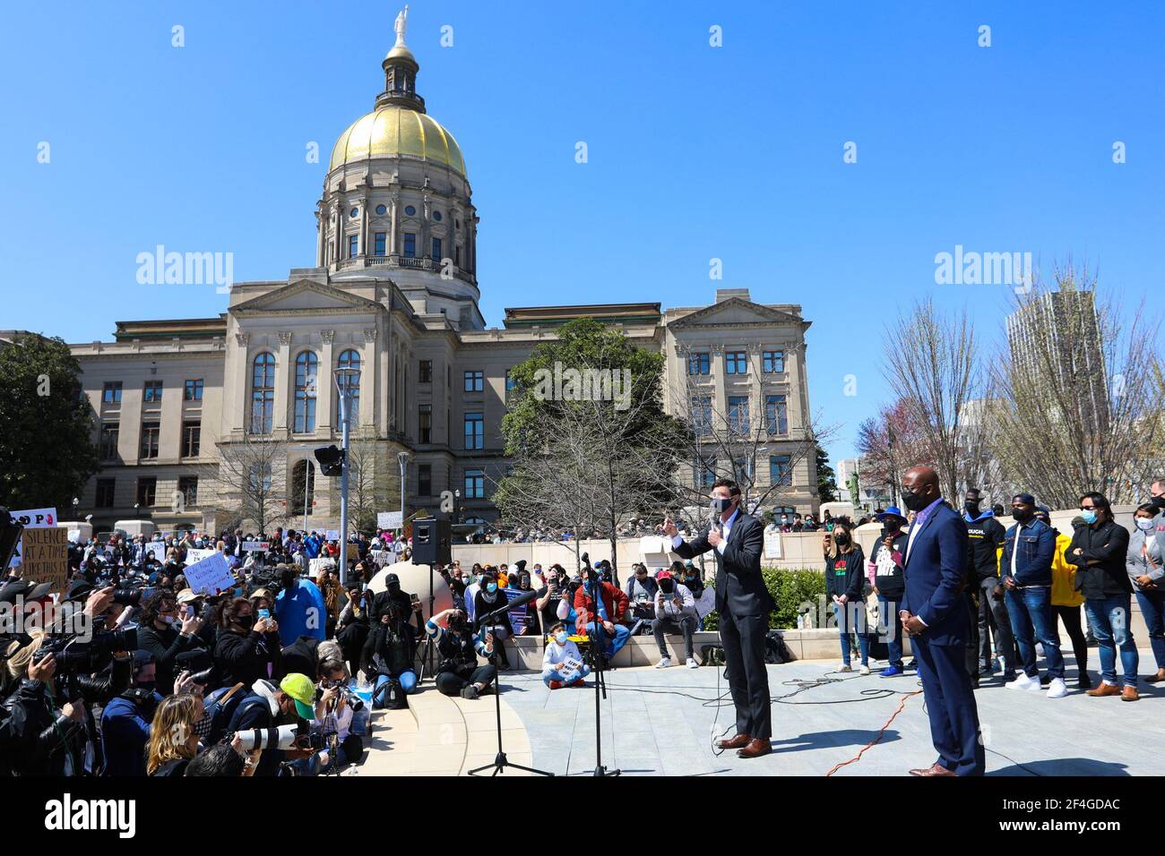 Atlanta, USA. 20th Mar, 2021. Georgia's two newly-elected senators, Raphael Warnock (R, front) and Jon Ossoff (L, front) attend a gathering to protest hate crimes against Asian Americans in Atlanta, Georgia, the United States, March 20, 2021. Hundreds of protesters of all ages and ethnicities gathered Saturday in Atlanta, Georgia, to protest hate crimes against Asian Americans, days after multiple shootings in and around the city killed eight people, among whom six were Asian women. Credit: XiaoHeng Wang/Xinhua/Alamy Live News Stock Photo