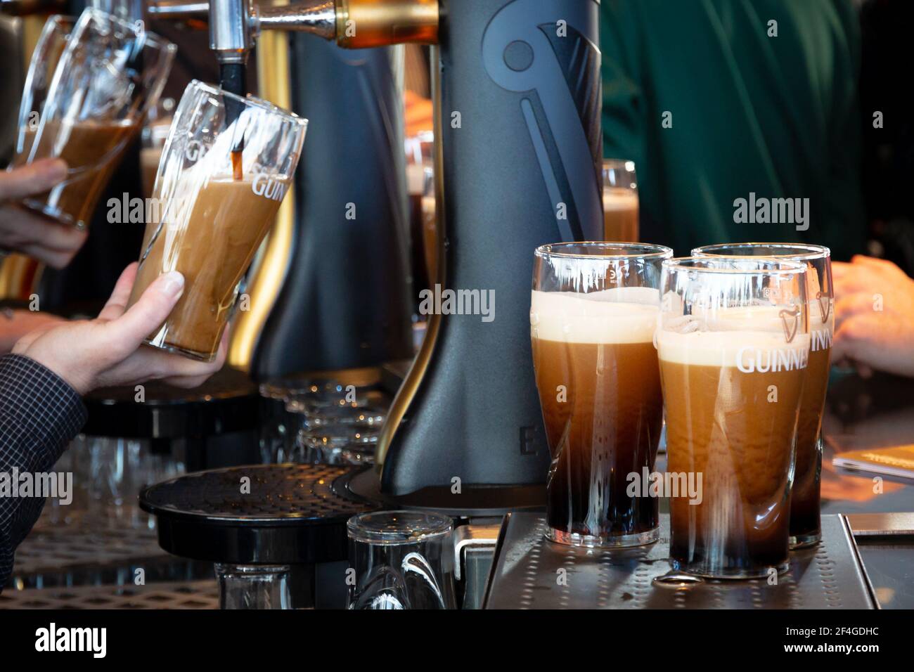 Pints of Guinness are being served in a pub in Dublin, Ireland - February 15, 2014 Stock Photo