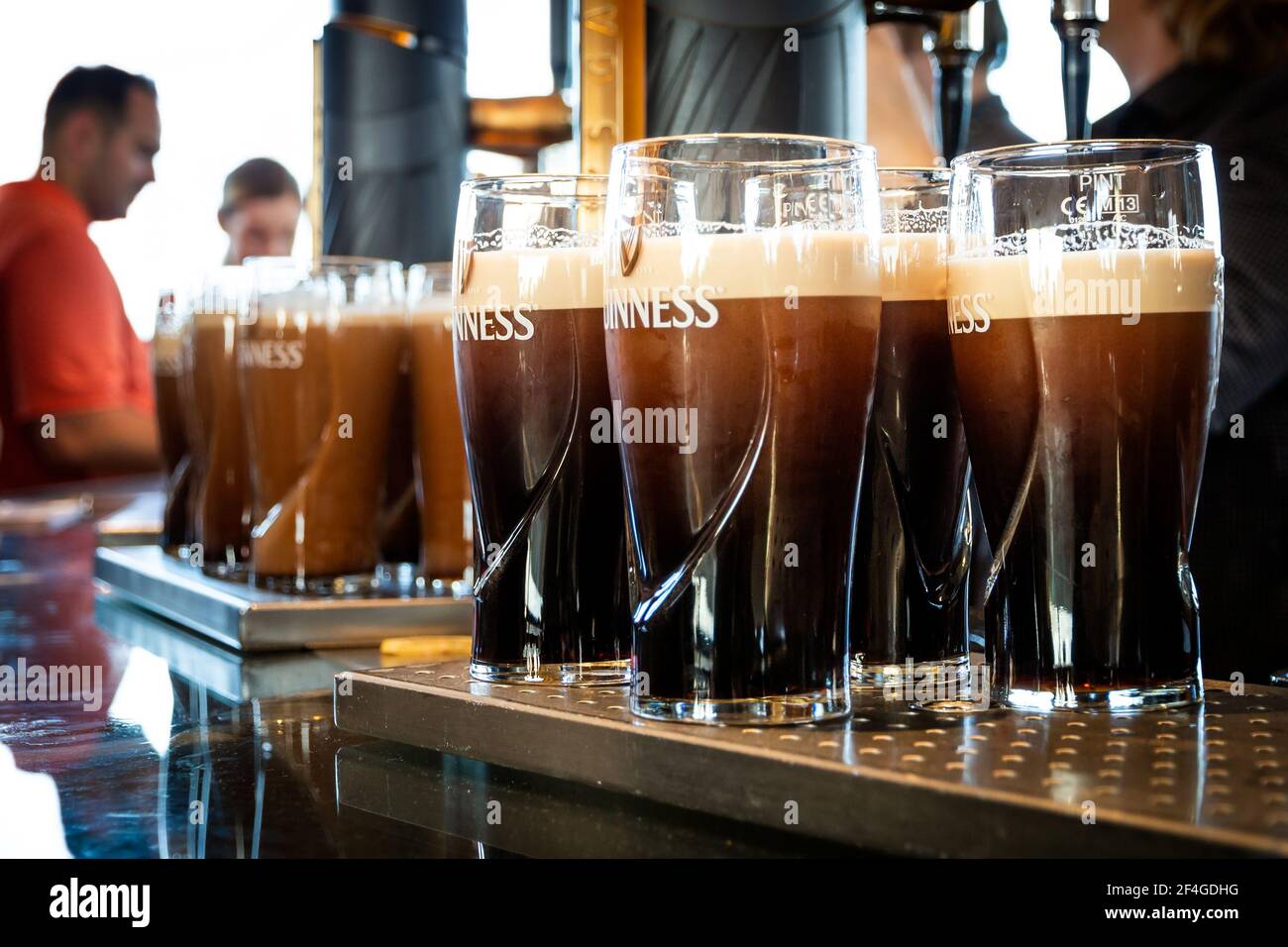 Pints of Guinness are being served in a pub in Dublin, Ireland - February 15, 2014 Stock Photo