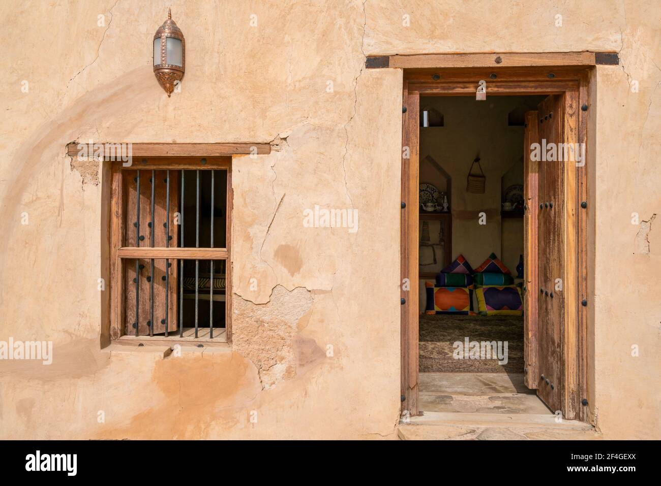 Wooden door and window leading into a room in medieval arabian fortress. Castle of Nakhal, Oman. Islamic architecture. Medieval middle east castle. Stock Photo