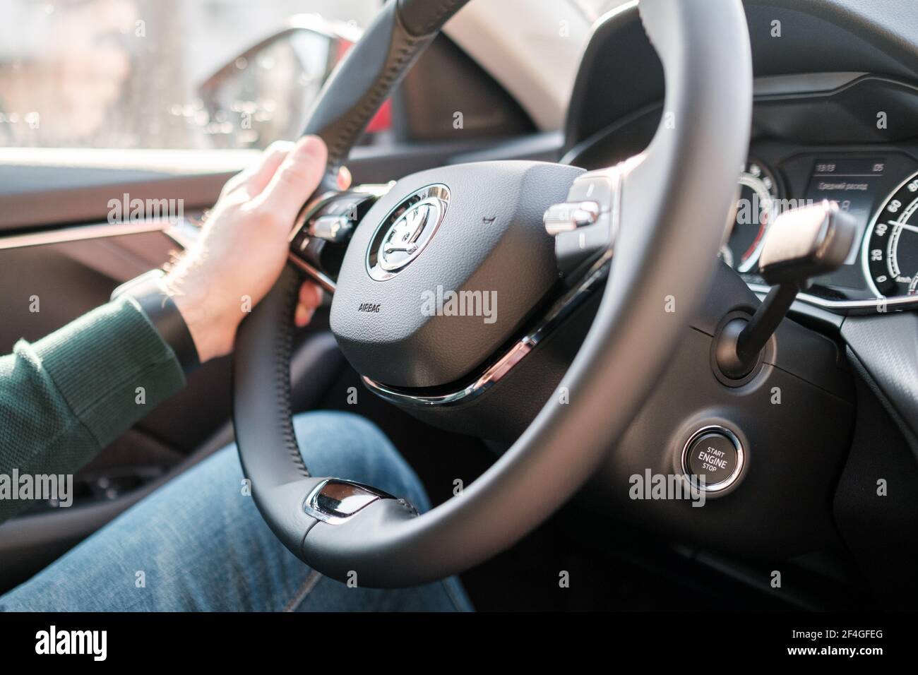 Man driving new Skoda auto. Driving a car. Mans hand on the wheel. Rental car concept, March 2021, Prague, Czech Republic Stock Photo