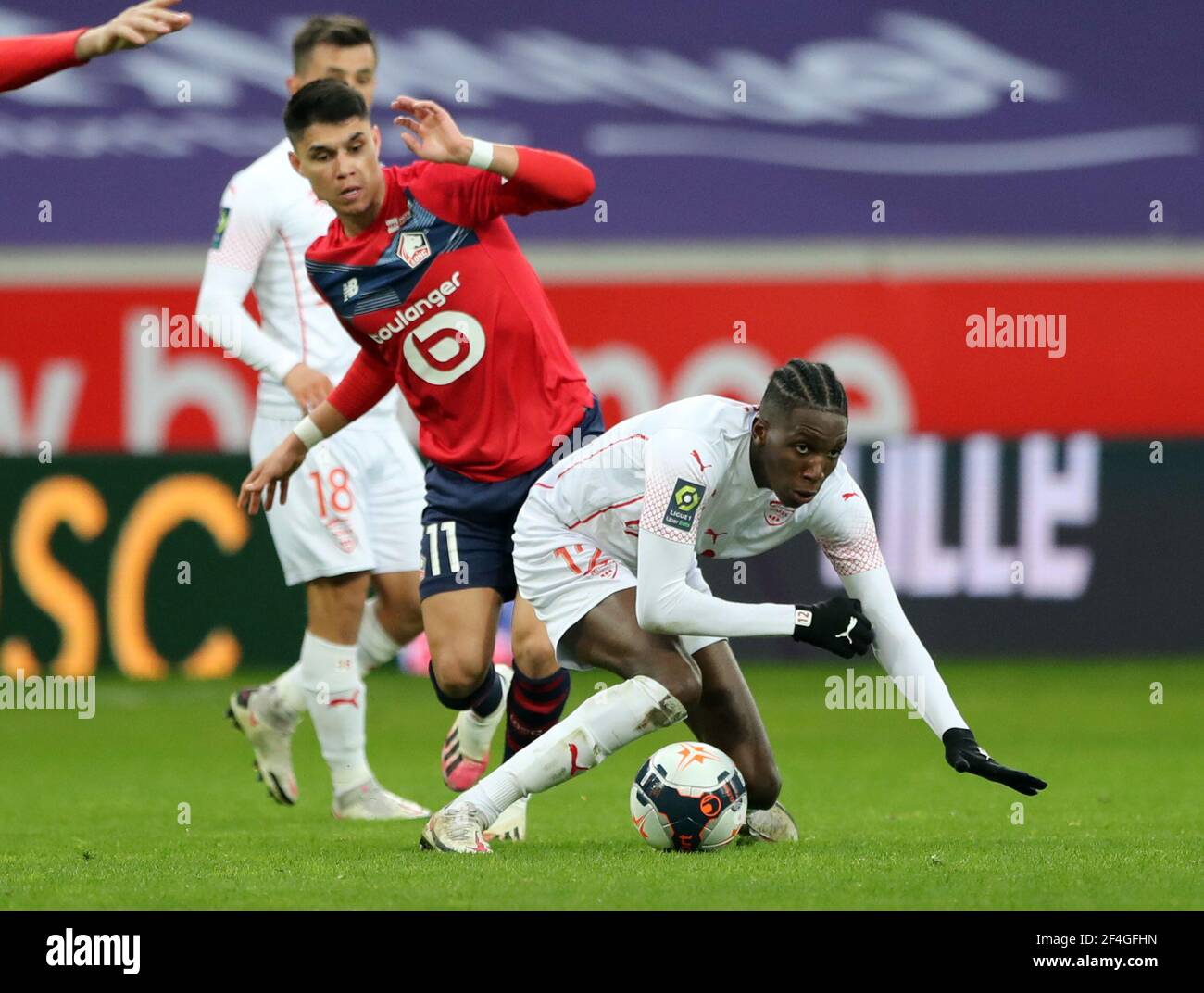 Soccer Football - Ligue 1 - Lille v Nimes Olympique - Stade Pierre-Mauroy,  Lille, France - March 21, 2021 Lille's Luiz Araujo in action with Nimes  Olympique's Lamine Fomba REUTERS/Pascal Rossignol Stock Photo - Alamy