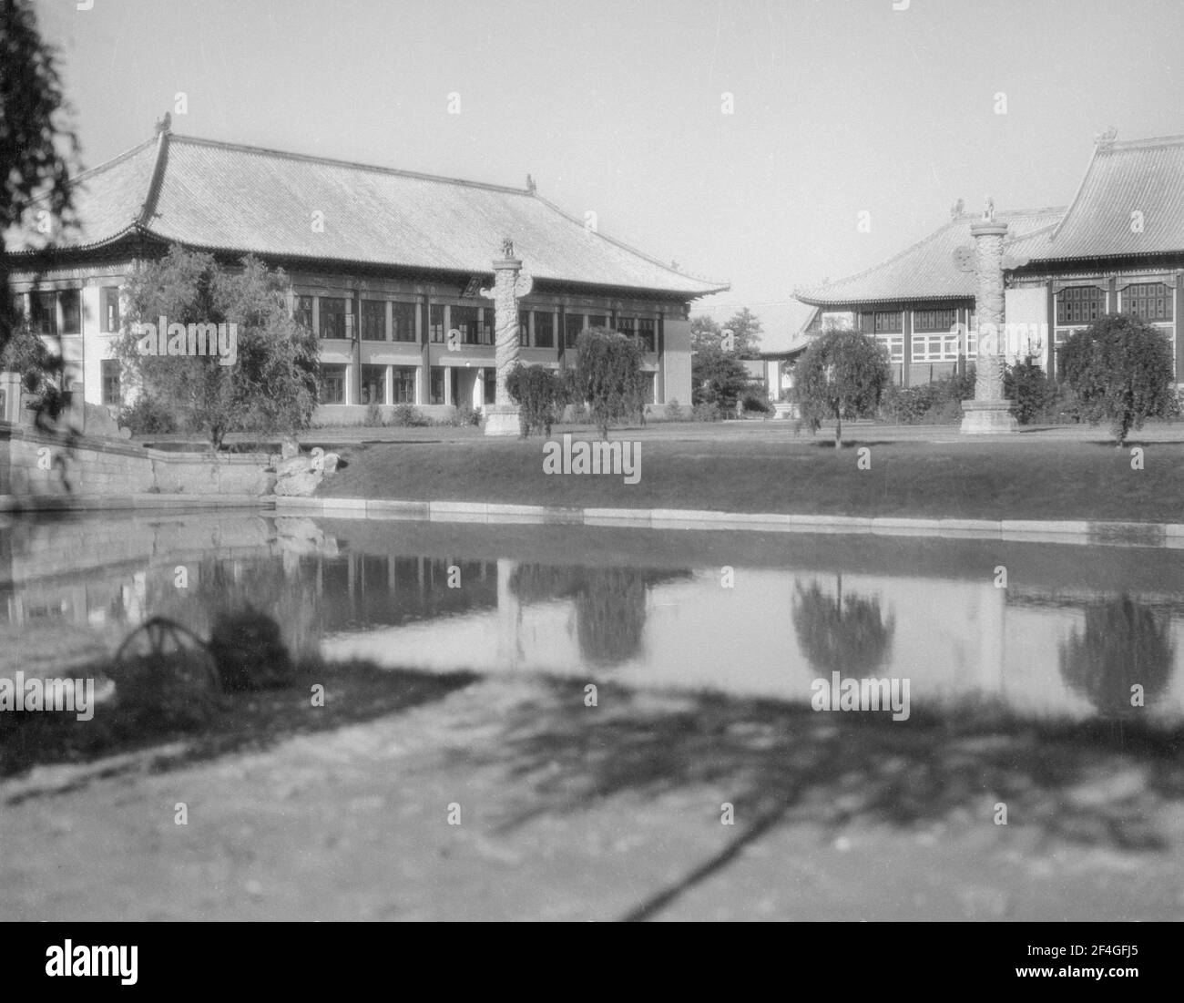 Building with reflection in water, China, Beijing (China), Yanjing da xue, 1931. From the Sidney D. Gamble photographs collection. () Stock Photo