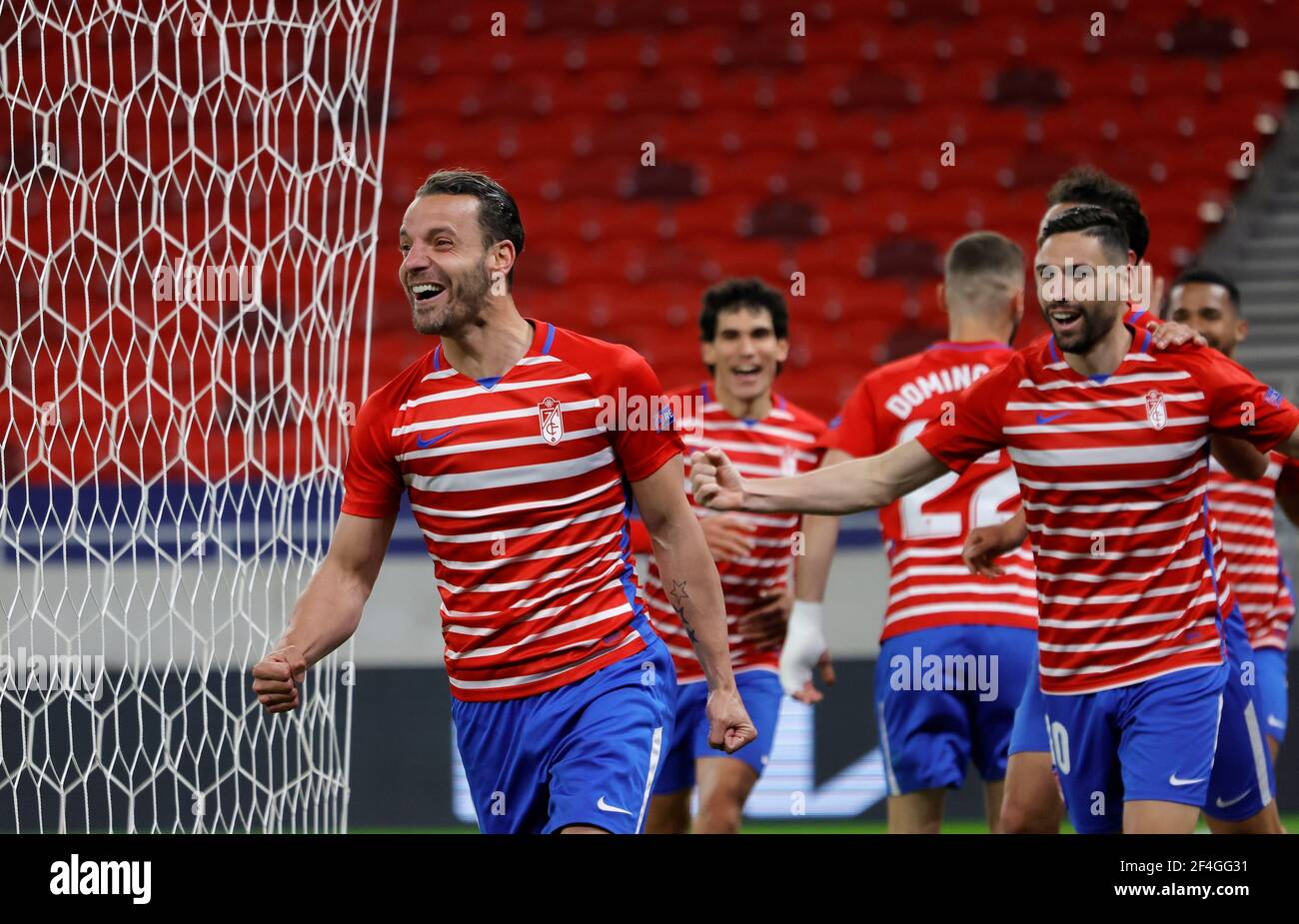 BUDAPEST, HUNGARY - MARCH 18: Roberto Soldado of Granada CF celebrates his goal with teammates during the UEFA Europa League Round of 16 Second Leg match between Molde and Granada at Puskas Arena on March 18, 2021 in Budapest, Hungary. Sporting stadiums around Europe remain under strict restrictions due to the Coronavirus Pandemic as Government social distancing laws prohibit fans inside venues resulting in games being played behind closed doors. Stock Photo