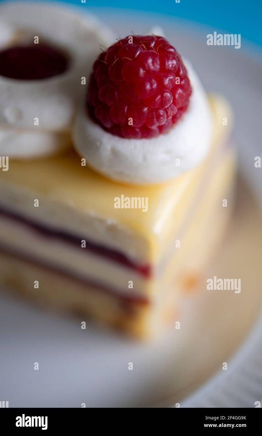 Close-up of a freshly made slice of cake with cream and jam Stock Photo