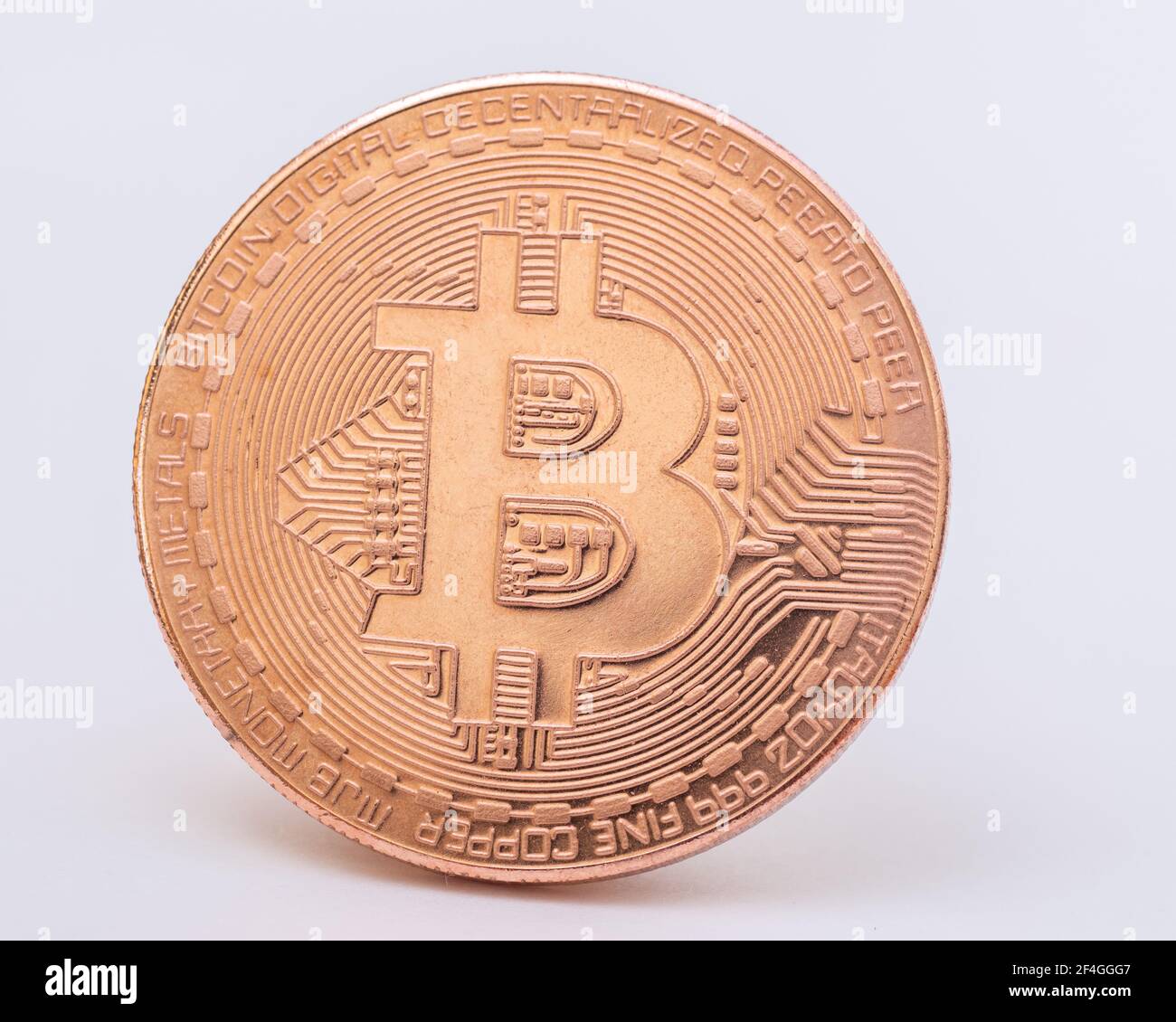 Gold bitcoin coin on a white background close-up. Physical bit coins. Digital currency. Cryptocurrency mining concept. Electronic money concept Stock Photo