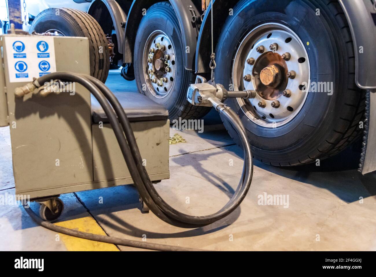 Pneumatic machine to tighten or loosen the lug nuts of a truck. Stock Photo
