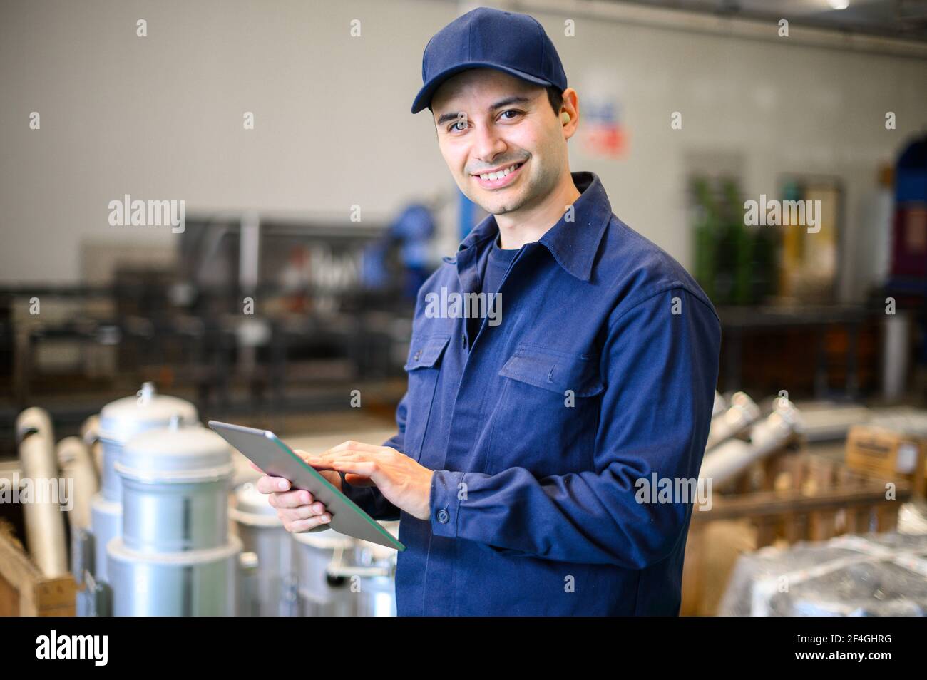 Portrait af an engineer using a tablet in a facility Stock Photo