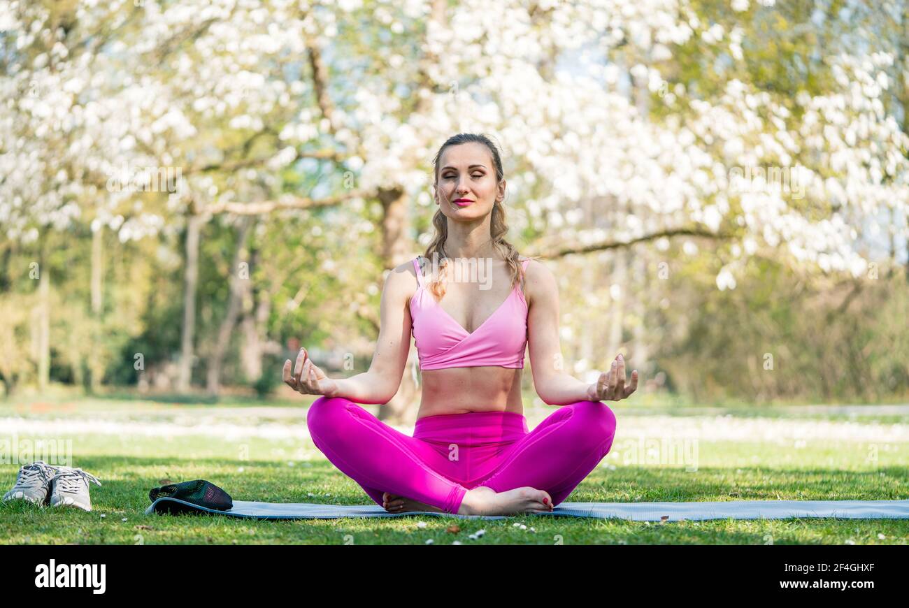 Young woman doing yoga in nature. Lotus figure. - a Royalty Free Stock  Photo from Photocase