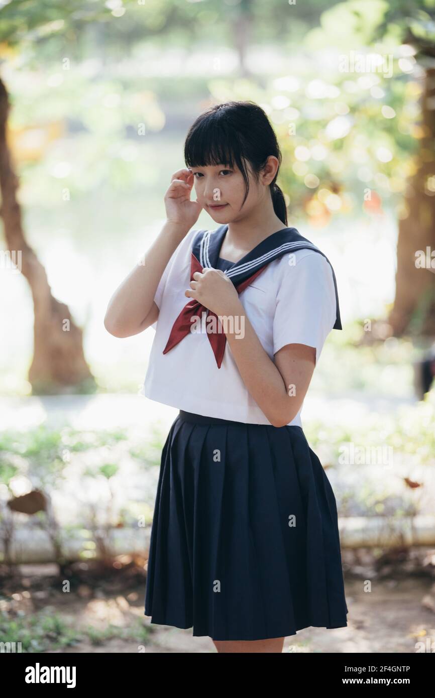 Portrait of asian japanese school girl costume looking at park