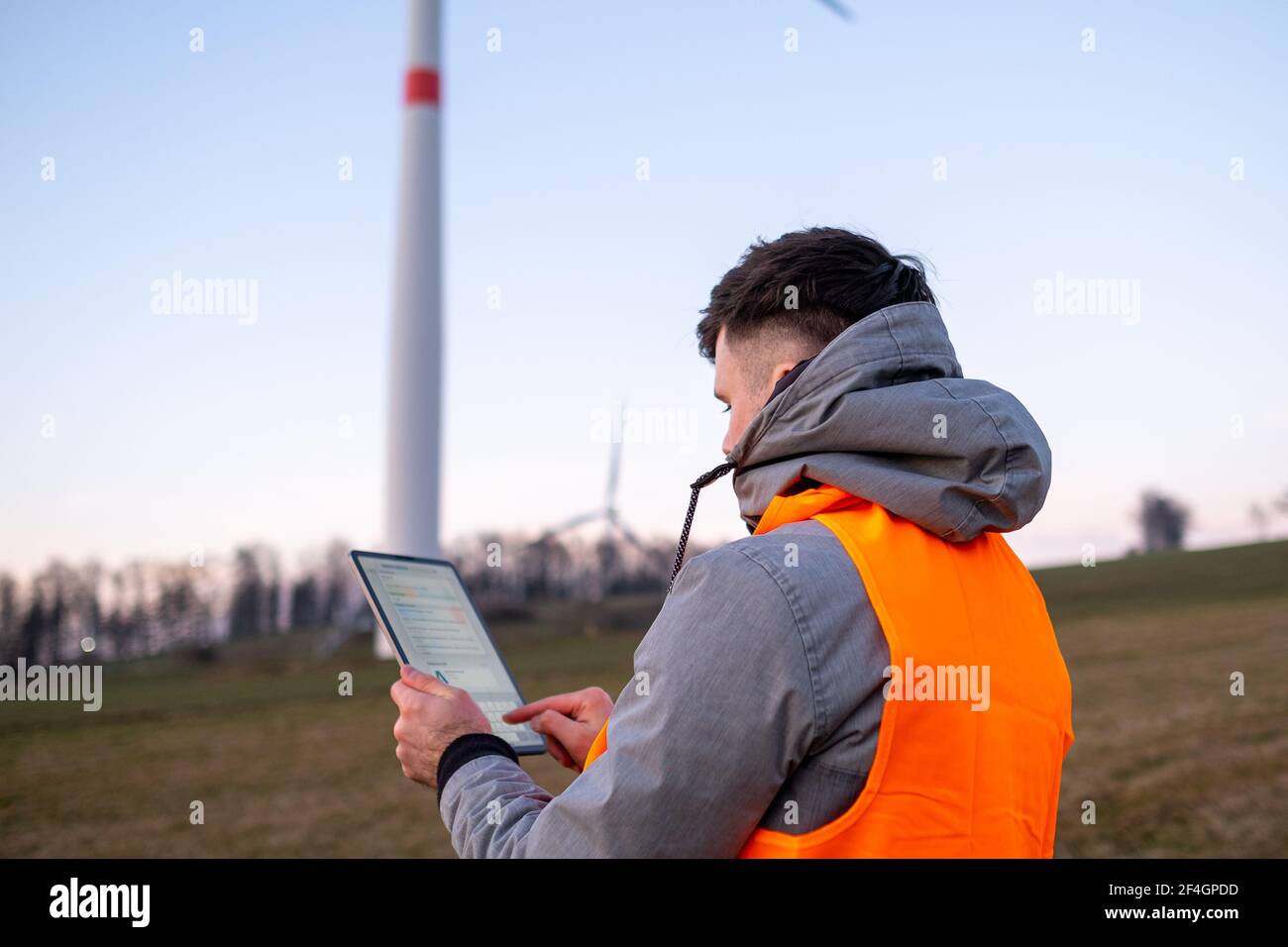 Electrical engineer checking or repairing wind turbines in the field